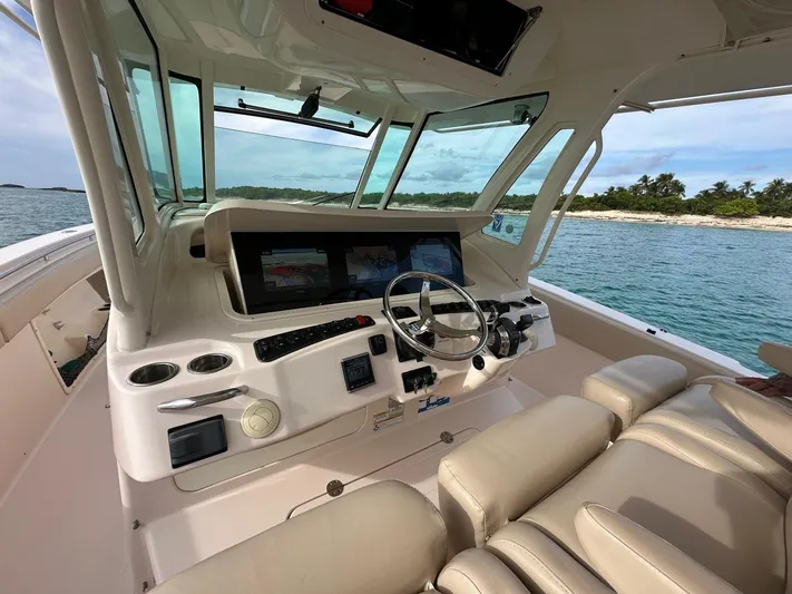  Yacht Photos Pics 2013 Grady-White Canyon 366 boat cockpit with steering wheel and navigation screens.