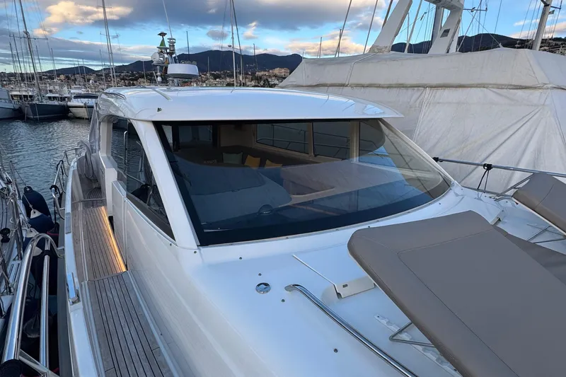 Annie Yacht Photos Pics 2023 Nimbus 405 Coup&eacute; yacht docked in marina, showcasing sleek design and spacious deck.