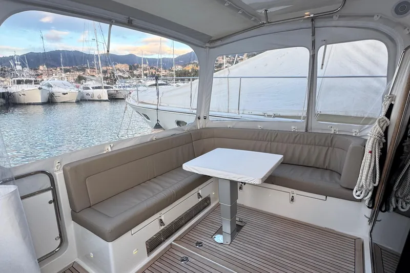 Annie Yacht Photos Pics Luxurious interior of 2023 Nimbus 405 Coup&eacute; yacht with seating and table.