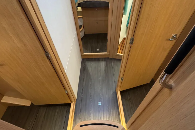 Annie Yacht Photos Pics Interior hallway of 2023 Nimbus 405 Coup&eacute; with wooden doors and flooring.