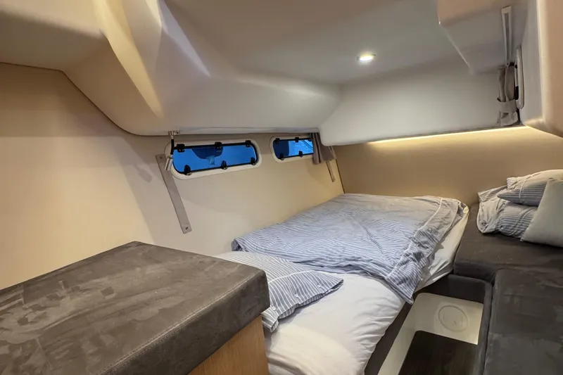 Annie Yacht Photos Pics Cozy cabin interior of 2023 Nimbus 405 Coup&eacute; with comfortable bedding and ambient lighting.