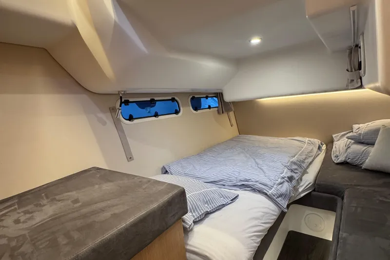 Annie Yacht Photos Pics Cozy cabin interior of 2023 Nimbus 405 Coup&eacute; with comfortable bedding and ambient lighting.