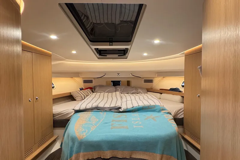 Annie Yacht Photos Pics Luxurious cabin interior of 2023 Nimbus 405 Coup&eacute; yacht with cozy bedding.