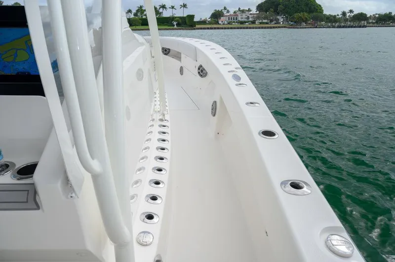  Yacht Photos Pics 2023 SeaVee 420Z boat deck with rod holders, cruising on calm water.