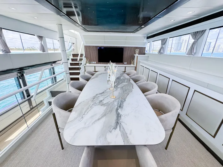  Yacht Photos Pics Luxurious dining area on a 2010 Custom WHS Marine yacht with marble table and panoramic windows.