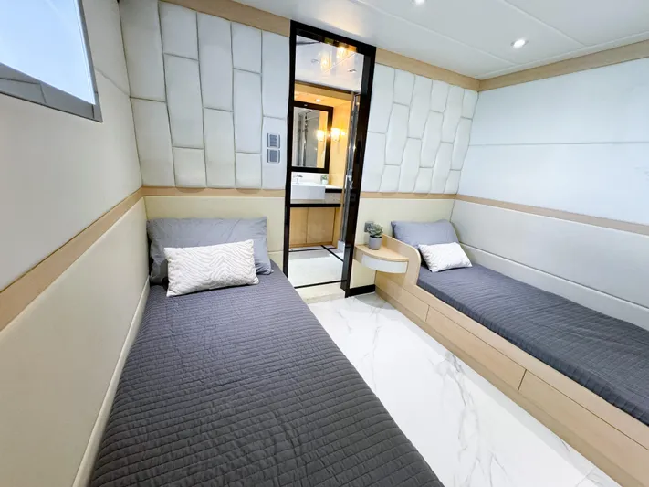  Yacht Photos Pics Modern twin cabin interior of 2010 Custom WHS Marine yacht with sleek design and comfortable bedding.