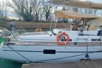 2002 Comar Comet 51 Dh yacht docked, featuring lifebuoys and Italian flag.