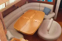 Luxurious interior of 2002 Comar Comet 51 Dh yacht with elegant seating and wooden table.