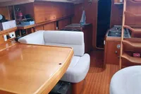 Interior of 2002 Comar Comet 51 Dh yacht with wooden furnishings and seating area.