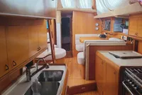 Interior of 2002 Comar Comet 51 Dh yacht with wooden cabinetry and modern amenities.