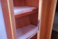 Bunk beds in 2002 Comar Comet 51 Dh yacht interior, wooden finish.