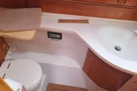 Bathroom interior of 2002 Comar Comet 51 Dh yacht, featuring sink and toilet.