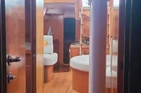 Interior of 2002 Comar Comet 51 Dh yacht with wooden flooring and seating area.