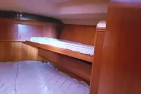 Interior cabin of 2002 Comar Comet 51 Dh yacht with wooden finish and bedding.