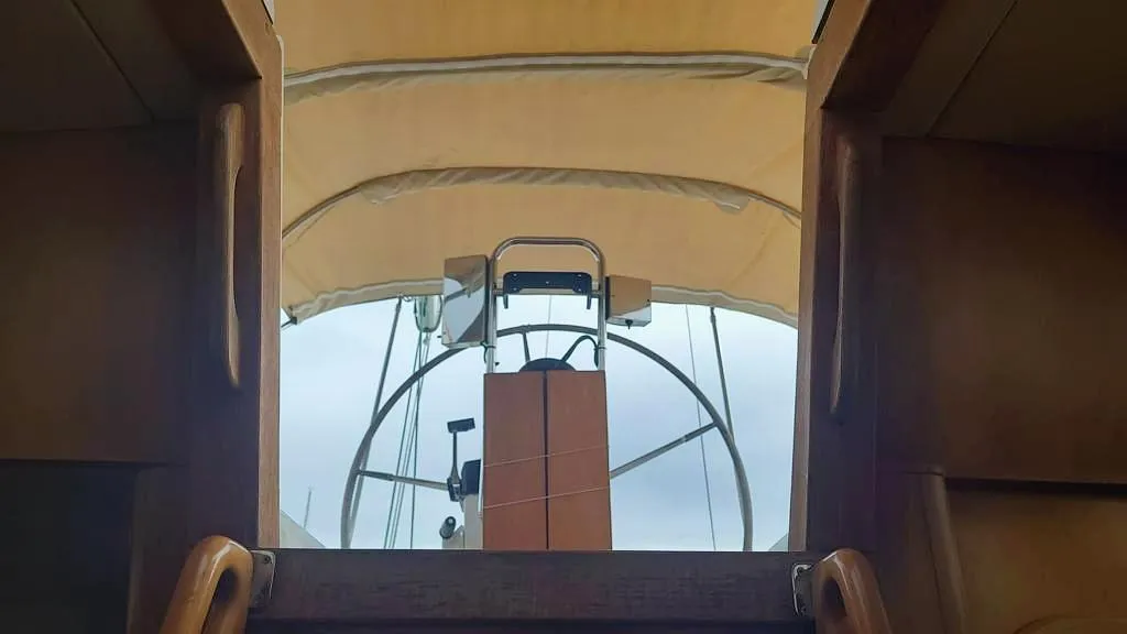 Cockpit view of 2002 Comar Comet 51 Dh sailboat with covered helm.