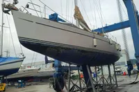 Sailboat Comar Comet 51 Dh 2002 on a lift in a shipyard.
