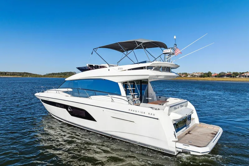 Yacht Photos Pics 2019 Prestige 520 yacht cruising on a sunny day, showcasing sleek design and luxury features.