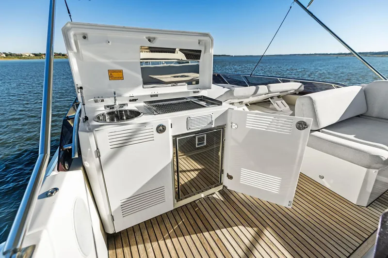  Yacht Photos Pics Luxury yacht Prestige 520, 2019 model, featuring outdoor kitchenette and seating area on deck.