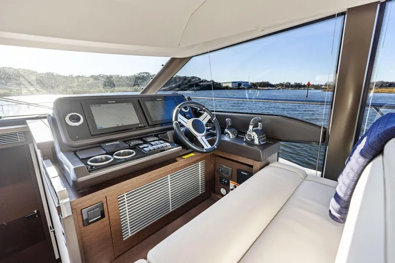  Yacht Photos Pics Luxurious 2019 Prestige 520 yacht helm with modern controls and scenic water view.