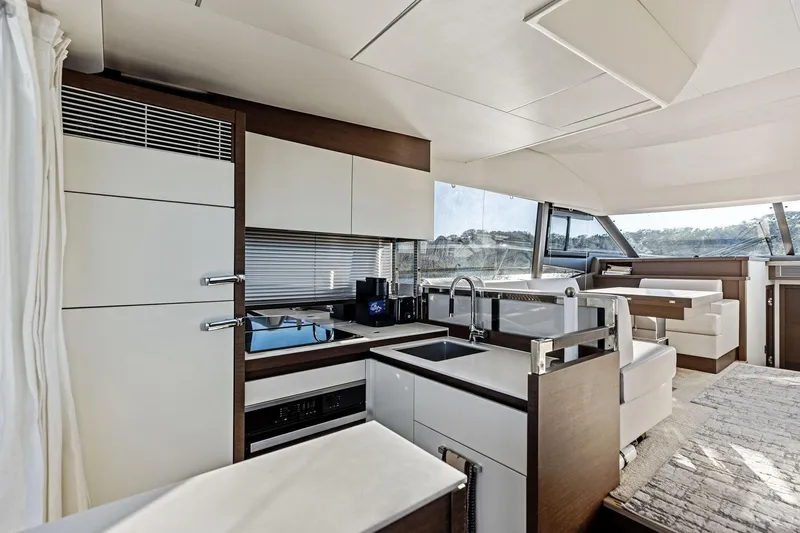  Yacht Photos Pics Luxurious interior of 2019 Prestige 520 yacht featuring modern kitchen and seating area.
