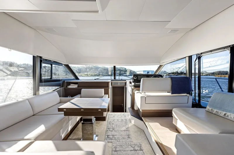  Yacht Photos Pics Luxurious interior of 2019 Prestige 520 yacht with elegant seating and panoramic windows.