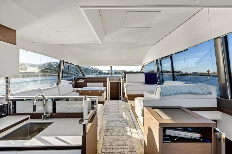  Yacht Photos Pics Luxurious interior of 2019 Prestige 520 yacht with modern furnishings and panoramic windows.