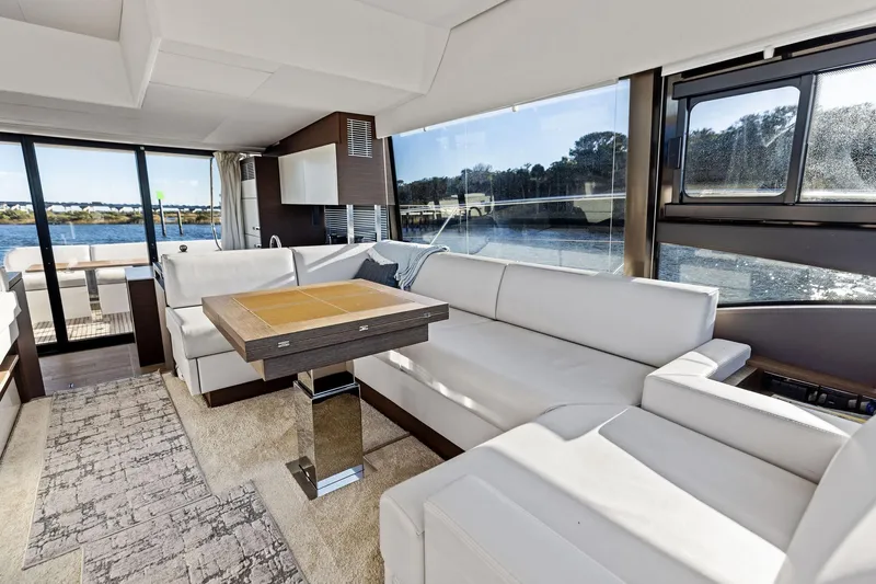  Yacht Photos Pics Luxurious interior of 2019 Prestige 520 yacht with white seating and scenic water view.