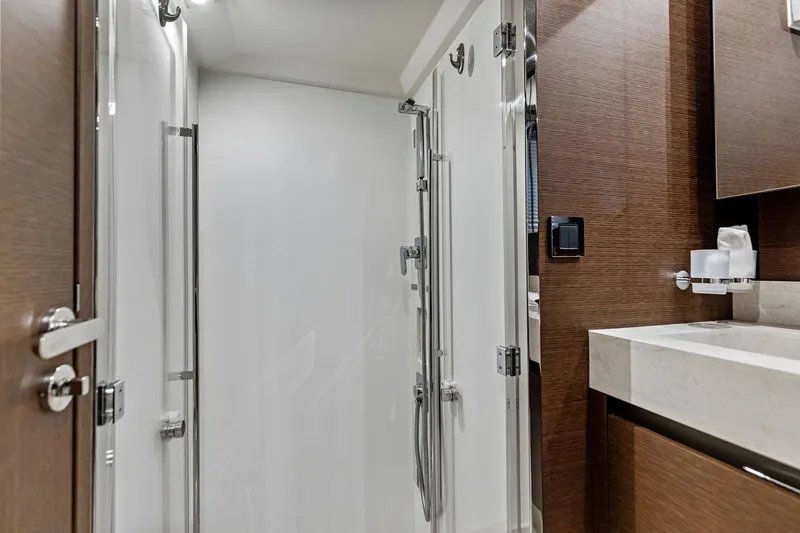  Yacht Photos Pics Luxurious bathroom interior of 2019 Prestige 520 yacht with modern fixtures and wood accents.