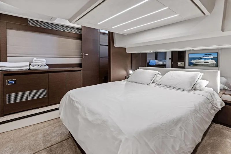  Yacht Photos Pics Luxurious bedroom interior of 2019 Prestige 520 yacht with modern design and elegant furnishings.