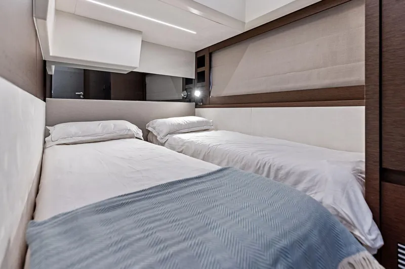  Yacht Photos Pics Luxurious twin cabin interior of 2019 Prestige 520 yacht, featuring modern design and cozy bedding.