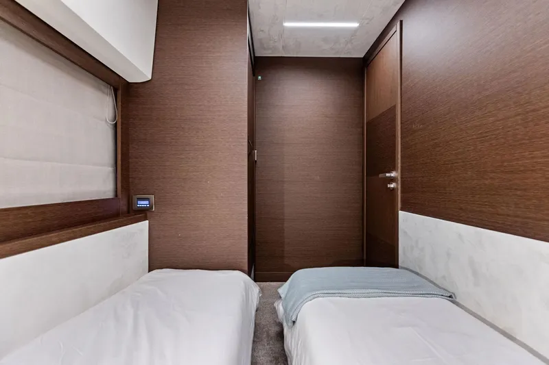  Yacht Photos Pics Luxurious twin cabin interior of 2019 Prestige 520 yacht with modern wood paneling.