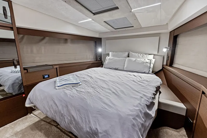  Yacht Photos Pics Luxurious bedroom interior of 2019 Prestige 520 yacht with modern design and cozy bedding.