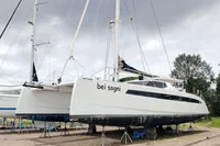 2023 Seawind 1600 Passagemaker catamaran on land, named "bei sogni," under cloudy sky.