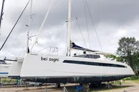 2023 Seawind 1600 Passagemaker catamaran on land, named "bei sogni," under cloudy skies.