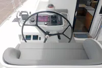 Helm of 2023 Seawind 1600 Passagemaker, featuring modern navigation controls and comfortable seating.