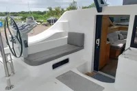 2023 Seawind 1600 Passagemaker yacht cockpit with helm, seating, and interior view.