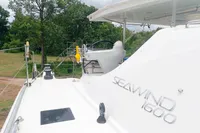 2023 Seawind 1600 Passagemaker yacht on deck, surrounded by lush greenery.