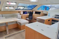 Luxurious interior of 2023 Seawind 1600 Passagemaker catamaran with modern kitchen and seating area.
