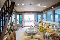 Luxurious interior of 2012 Bering 60 yacht with elegant dining setup and ocean view.