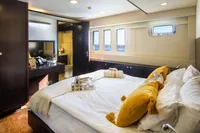 Luxurious cabin interior of 2012 Bering 60 yacht with cozy bed and elegant decor.