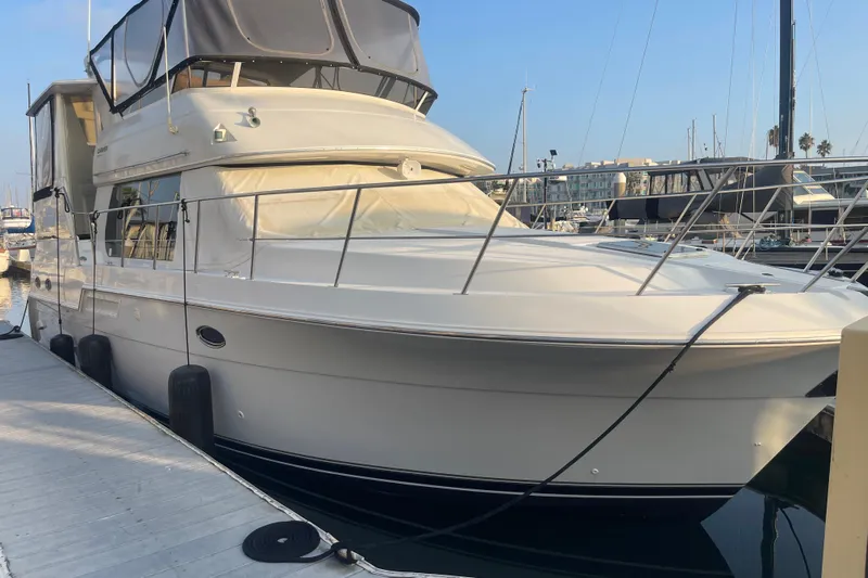  Yacht Photos Pics 1988 Marine Trader Aft Cabin yacht docked at marina under clear sky.