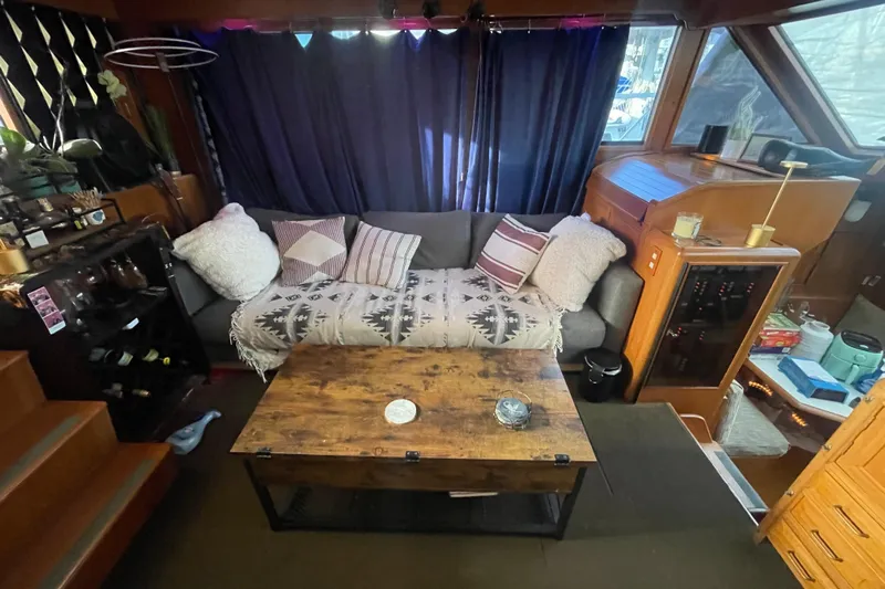  Yacht Photos Pics Cozy 1988 Marine Trader Aft Cabin interior with sofa, wooden table, and nautical decor.