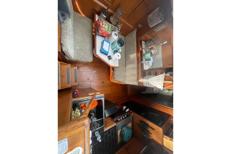  Yacht Photos Pics 1988 Marine Trader Aft Cabin interior with cozy seating, wooden cabinetry, and nautical decor.