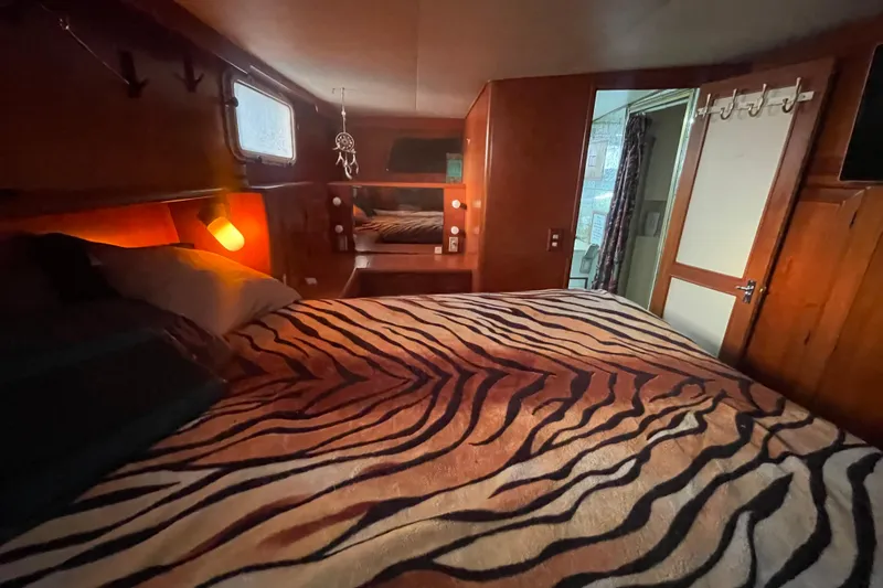  Yacht Photos Pics Cozy 1988 Marine Trader Aft Cabin with zebra-patterned bedding and warm lighting.