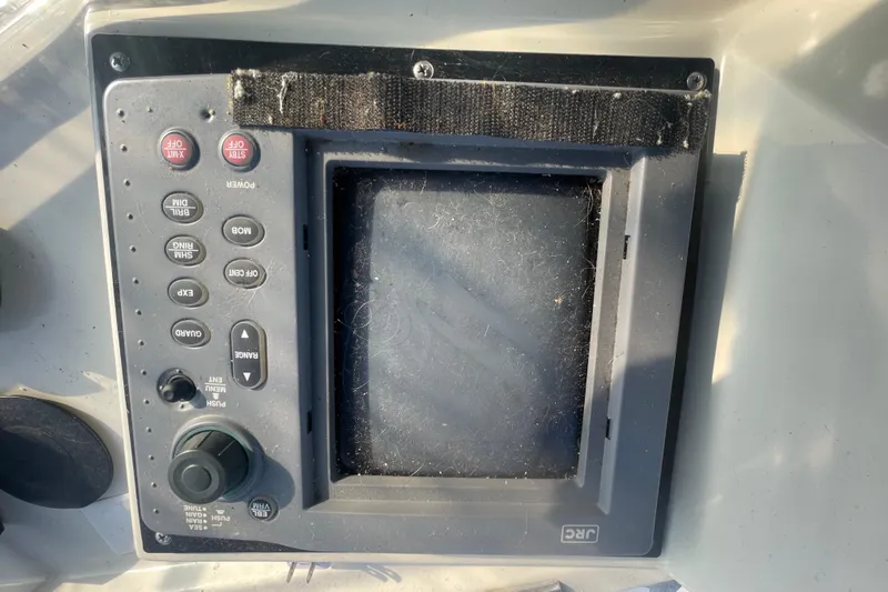  Yacht Photos Pics Control panel of a 1988 Marine Trader Aft Cabin boat, featuring various buttons and a screen.