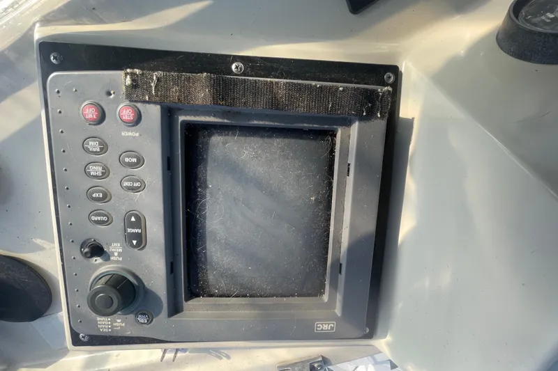  Yacht Photos Pics Control panel of a 1988 Marine Trader Aft Cabin boat, featuring various buttons and a screen.