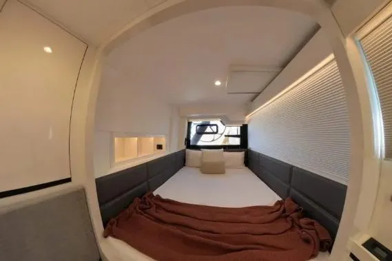 Curiosity Yacht Photos Pics 2024 HH Catamarans OC 44 interior cabin with modern design and cozy bedding.