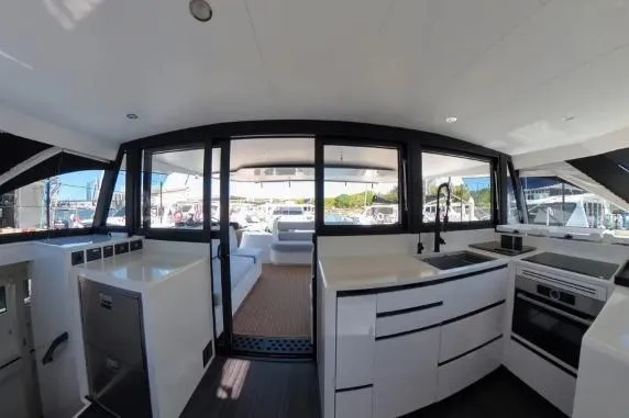 Curiosity Yacht Photos Pics 2024 HH Catamarans OC 44 interior with modern kitchen and spacious seating area.