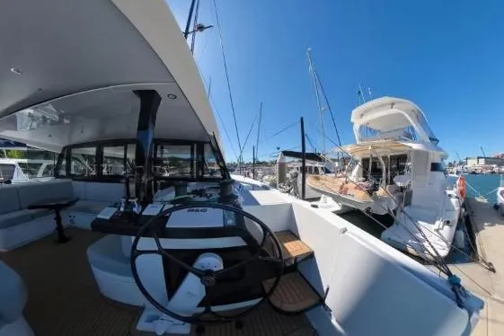 Curiosity Yacht Photos Pics 2024 HH Catamarans OC 44 yacht docked, showcasing helm and deck under clear blue sky.