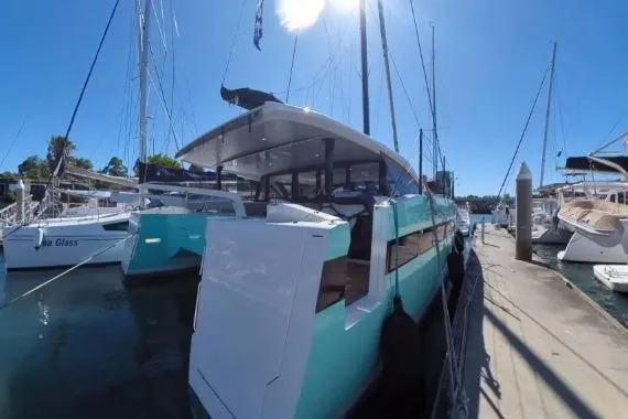 Curiosity Yacht Photos Pics 2024 HH Catamarans OC 44 docked at marina under clear blue sky.